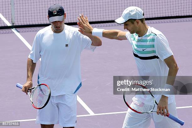 Max Mirnyi of Belarus and Andy Ram of Israel compete against Jeff Coetzee of South Africa and Wesley Moodie of South Africa during day nine of the...