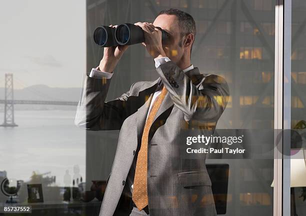 businessman in office with reflection - spy glass businessman stock pictures, royalty-free photos & images