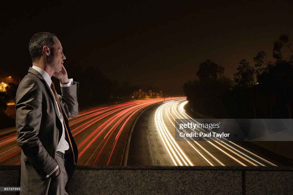 Businessman overlooking freeway