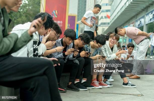 Young players practice outside the shopping mall, where a battle match of mobile game Arena of Valor is held. Arena of Valor: 5v5 Arena Game, China's...