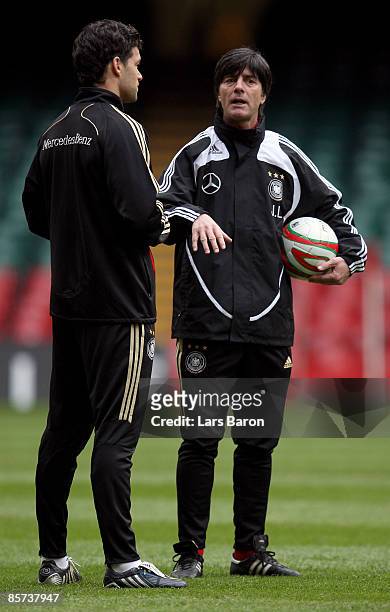 Michael Ballack speaks with head coach Joachim Loew during the German national team training session at the Millennium stadium on March 31, 2009 in...