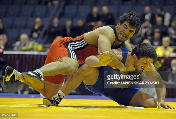 Ibragim Aldatov from Ukraine fights with Soslan Ktsoev from Russia in freestyle 84 kg category during Wrestling European Championship on March 31,...