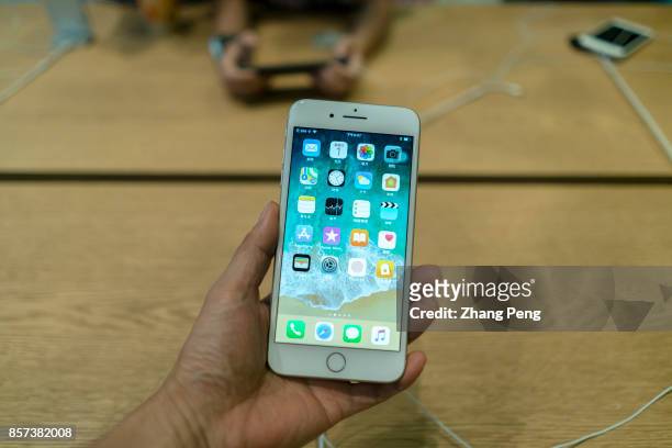 Chinese customers are trying the new iPhone 8 in an Apple store. In Sept., iPhone 8 arrived on the market, but in many Apple retail stores around the...