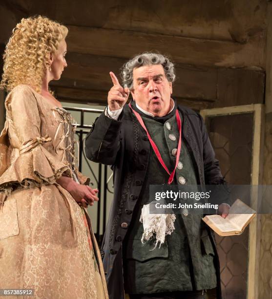 Sarah Tynan as Rosina and Alan Opie as Bartolo perform on stage during a performance of Jonathan Millers classic production of 'The Barber of...