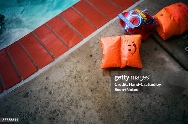 armband on poolside - arm floats stock pictures, royalty-free photos & images