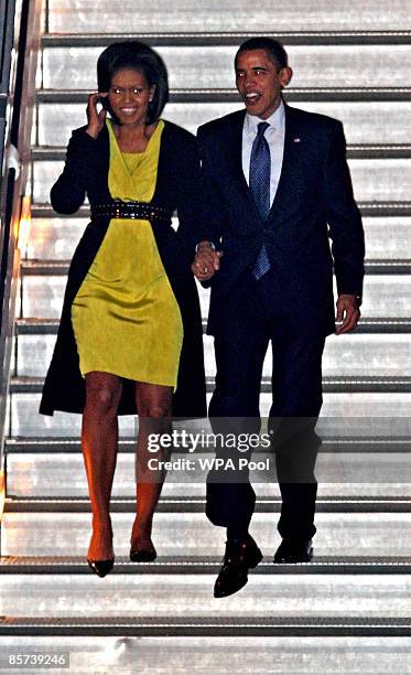 President Barack Obama and wife Michelle walk down the steps of Air Force One at Stansted Airport ahead of the G20 summit, on March 31, 2009 in...