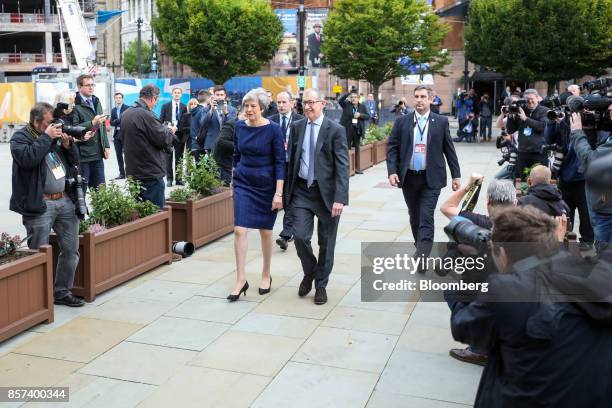 Theresa May, U.K. Prime minister and leader of the Conservative Party, left, and her husband, Philip May, arrive ahead of her speech at the party's...