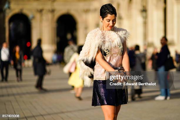 Chrisa Pappas wears a fur jacket, a lace top, a black skirt, outside Louis Vuitton, during Paris Fashion Week Womenswear Spring/Summer 2018, on...