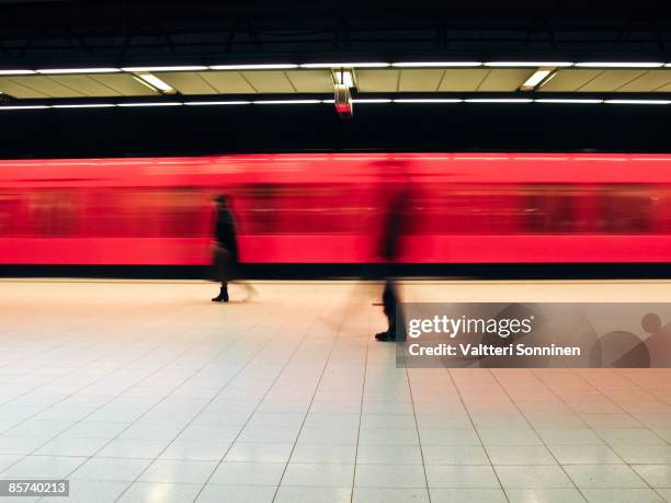 a moving subway train and people - helsinki stock pictures, royalty-free photos & images