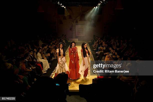 Models Vipasha Agarwal, Indrani Dasgupta and Amrit Maghera walk the runway at the Anamika Khanna show during the Lakme India Fashion Week...