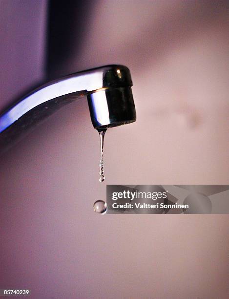water dripping from a faucet - faucet stock pictures, royalty-free photos & images