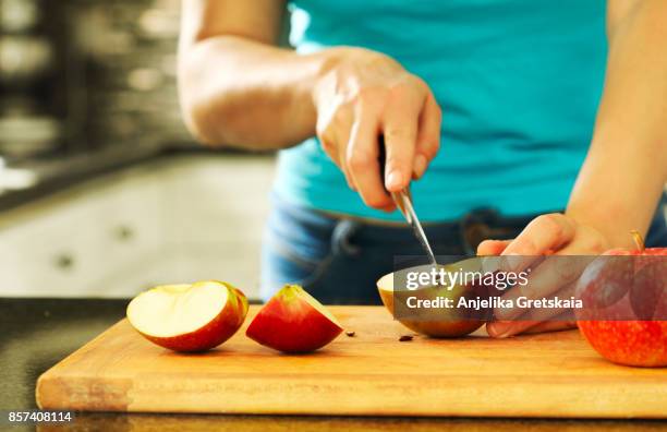 woman cutting fresh apples - apple cut out stock pictures, royalty-free photos & images