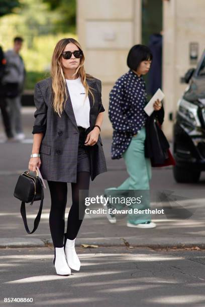 Miroslava Duma wears a blazer jacket, outside Miu Miu, during Paris Fashion Week Womenswear Spring/Summer 2018, on October 3, 2017 in Paris, France.