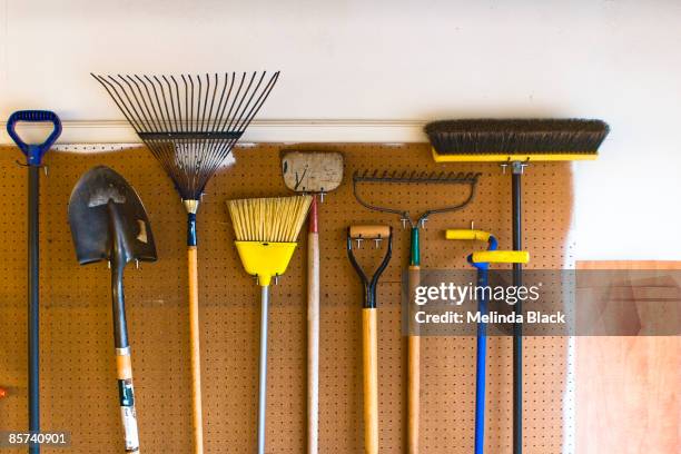 household and garden tools stored in garage - garage tools stock pictures, royalty-free photos & images