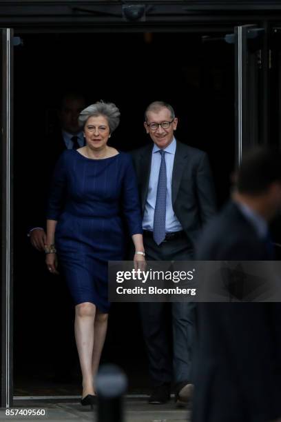 Theresa May, U.K. Prime minister and leader of the Conservative Party, left, and her husband, Philip May, arrive ahead of her speech at the party's...