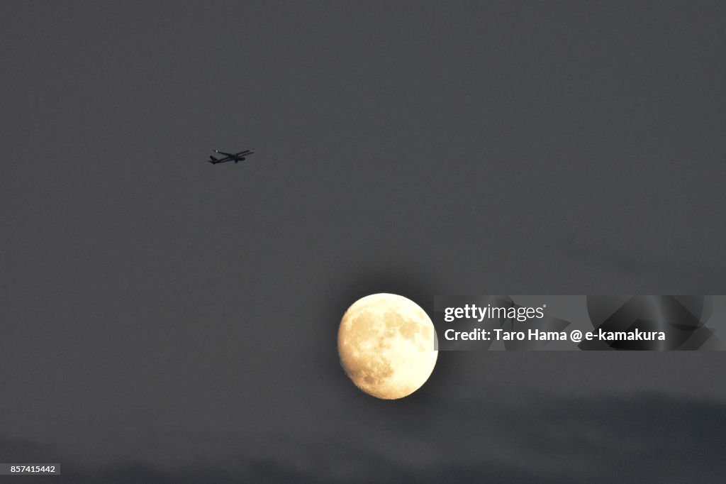 Flying airplane and moon