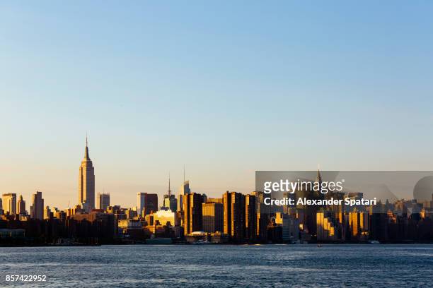 manhattan skyline and east river at sunset, new york city, usa - east village stock pictures, royalty-free photos & images