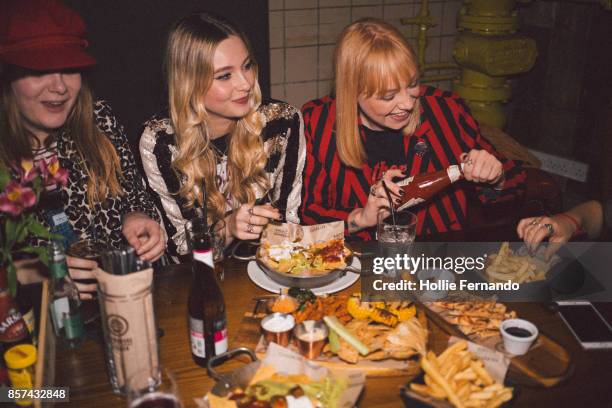 girlfriends on a night out - eating at restaurant stock pictures, royalty-free photos & images