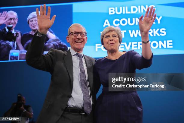 British Prime Minister Theresa May poses with husband Philip after delivering her keynote speech to delegates and party members on the last day of...