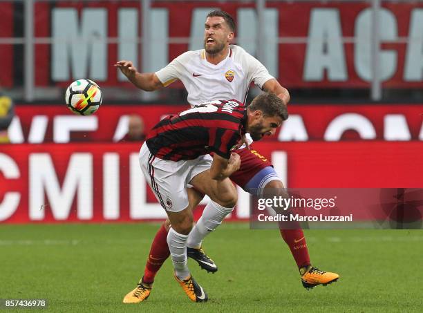 Kevin Strootman of AS Roma clashes with Fabio Borini of AC Milan during the Serie A match between AC Milan and AS Roma at Stadio Giuseppe Meazza on...