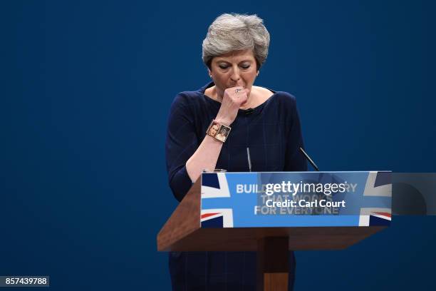 British Prime Minister Theresa May struggles with a cough as she delivers her keynote speech to delegates and party members on the last day of the...