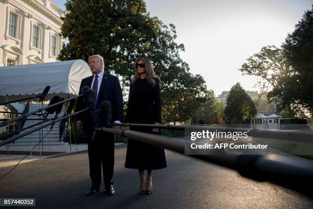 President Donald Trump and First Lady Melania Trump speak to the press as they depart the White House in Washington, DC, October 4 to travel to Las...