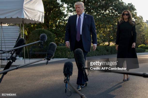 President Donald Trump and First Lady Melania Trump speak to the press as they depart the White House in Washington, DC, October 4 to travel to Las...