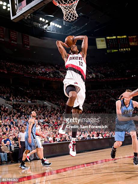 LaMarcus Aldridge of the Portland Trail Blazers goes up for a dunk past Andrei Kirilenko of the Utah Jazz during a game on March 31, 2009 at the Rose...
