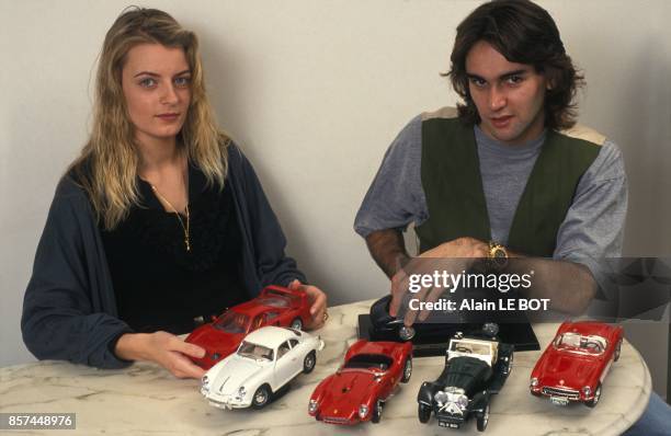 Le joueur du FC Nantes Reynald Pedros et sa collection de voitures miniatures et son amie Marjorie en fevrier 1993 a Nantes, France.