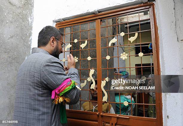 President of the Majlis-e-Ittehadul Muslimeen Asaduddin Owaisi greets residents as he campaigns at a residential area in the old city section of...