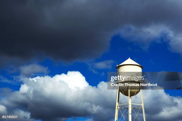 water tower and cloudy sky - water tower storage tank stock pictures, royalty-free photos & images