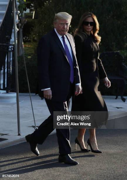 President Donald Trump and first lady Melania Trump come out from the residence prior to their departure from the South Lawn of the White House...