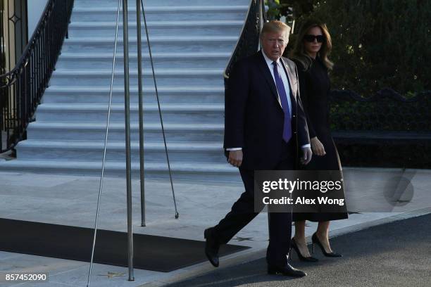 President Donald Trump and first lady Melania Trump come out from the residence prior to their departure from the South Lawn of the White House...