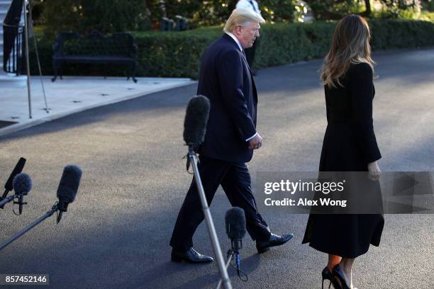 President Donald Trump and first lady Melania Trump walk away from the microphones after he spoke to members of the media prior to their departure...