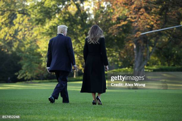 President Donald Trump and first lady Melania Trump walk towards the Marine One for their departure from the South Lawn of the White House October 4,...