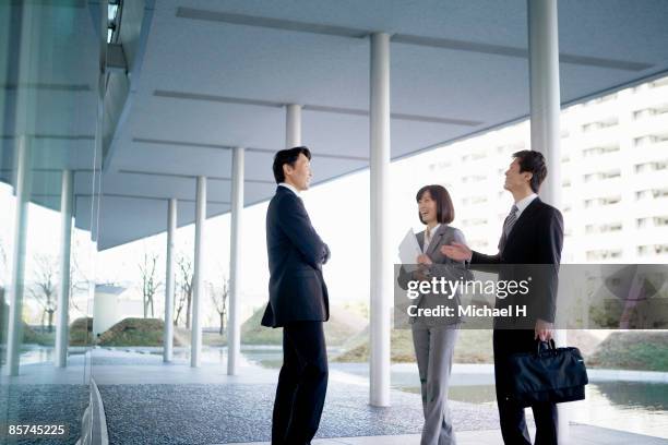 businessman who speaks happily with companion.  - 3人　ビジネス ストックフォトと画像