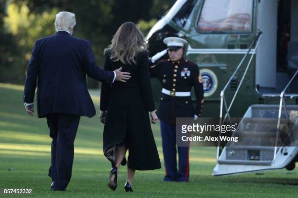 President Donald Trump and first lady Melania Trump walk towards the Marine One for their departure from the South Lawn of the White House October 4,...