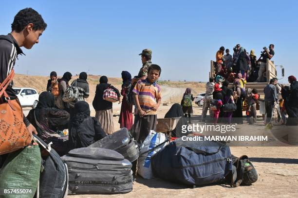 Displaced Iraqis who fled from the ongoing battles to oust the Islamic State group from Hawija, arrive in the area of Zarga some 35 kilometres...