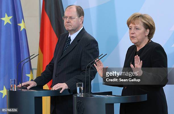 German Chancellor Angela Merkel and Finance Minister Peer Steinbrueck speak to the media before departing for the G20 group of nations summit in...