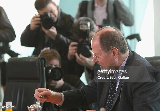 German Finance Minister Peer Steinbrueck prepares a pot of tea at the weekly German government cabinet meeting before departing for the G20 group of...