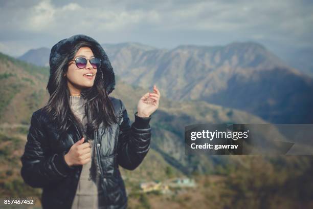 happy asian girl in mountains. - winter coat stock pictures, royalty-free photos & images