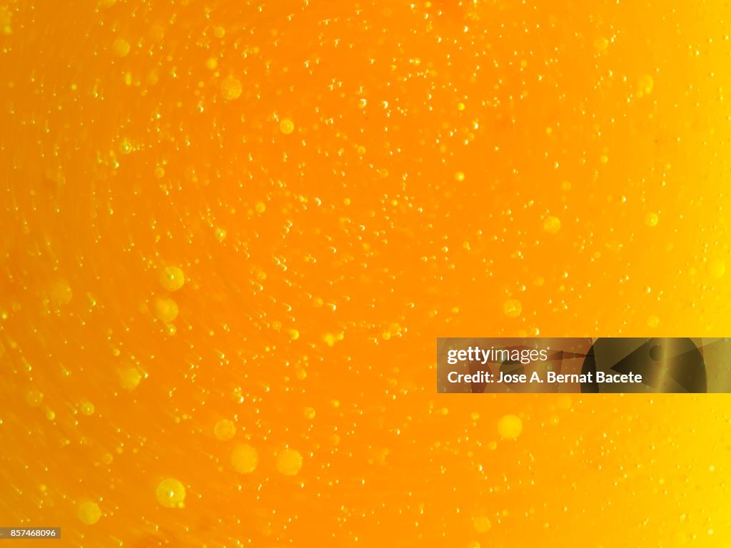 Full frame of abstract shapes and textures formed on a orange liquid background