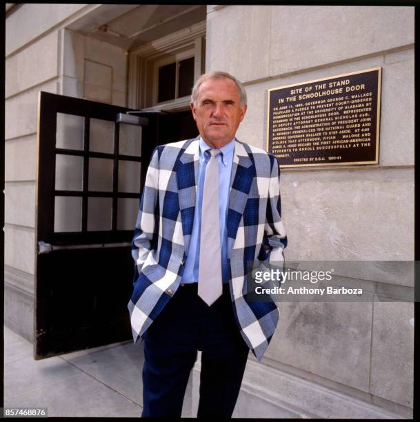 Portrait of American basketball coach Winfrey 'Wimp' Sanderson, of the University of Alabama, as he poses outside the university's Foster Auditorium,...