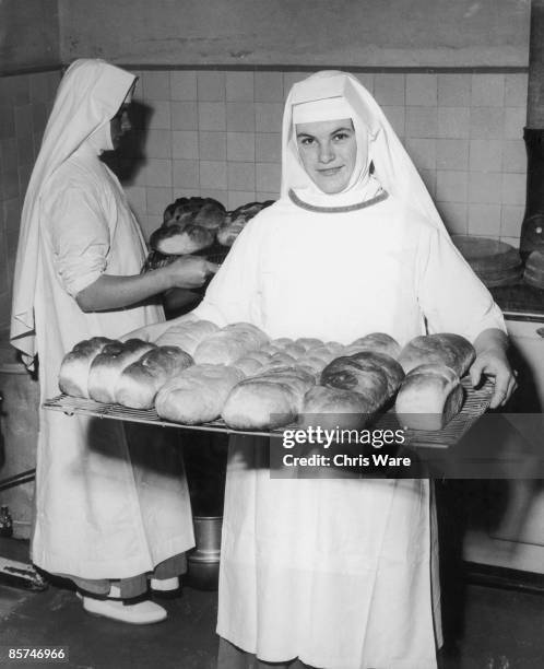 Nuns at Ladywell Convent in Godalming, Surrey, bake a batch of fresh loaves, 28th August 1962. All the Sisters acquire practical skills at the...