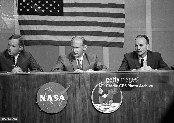 American astronauts Neil A. Armstrong, Edwin E. Aldrin, and Michael Collins take questions during a press conference less than two weeks before their...
