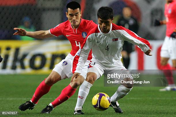 Pak Nam-Chol of North Korea and Cho Won-Hee of South Korea compete for the ball during the 2010 FIFA World Cup Asian Qualifying match between South...