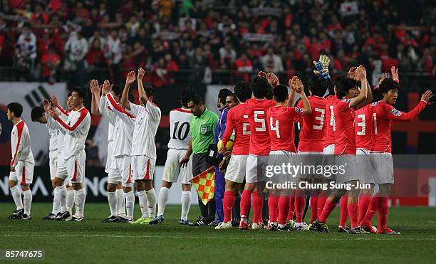 The South Korean national football team wave with North Korean national football team after the 2010 FIFA World Cup Asian Qualifying match between...