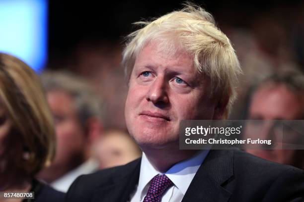 Foreign Secretary Boris Johnson looks on as Prime Minister Theresa May delivers her keynote speech to delegates and party members on the last day of...