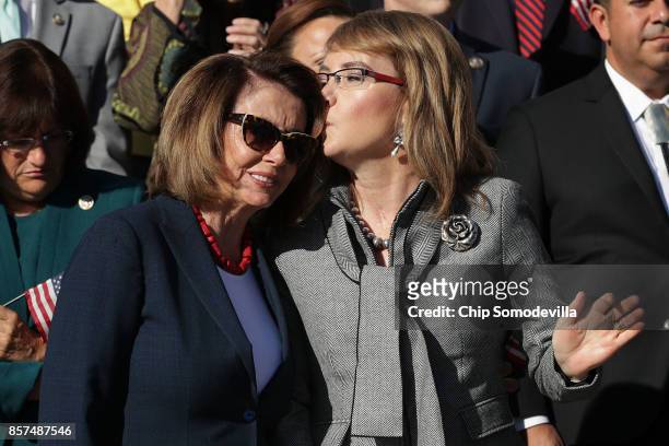 House Minority Leader Nancy Pelosi gets a kiss from former Congresswoman and gun violence victim Gabby Giffords durig a rally with fellow Democrats...