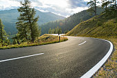 Asphalt road in Austria, Alps in a summer day
